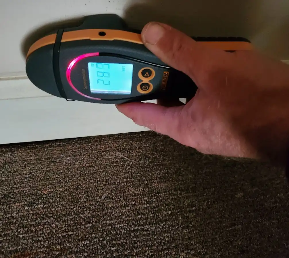 Moisture detection at baseboard during Storm Damage Restoration in Mantua